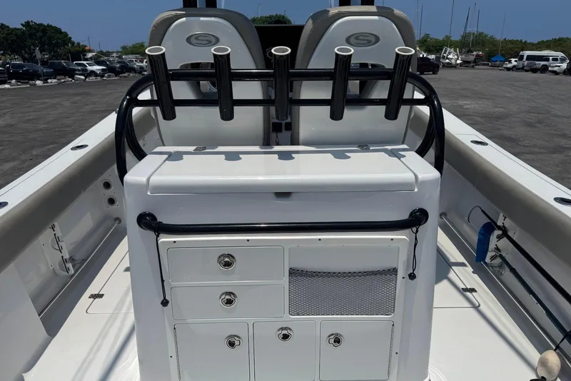 Slide: The Image of 2021 Sportsman Open 282 Center Console boat interior with rod holders and storage compartments. - 15