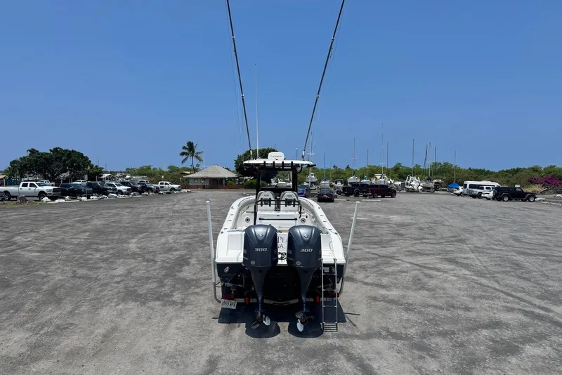 Slide: The Image of 2021 Sportsman Open 282 Center Console boat with dual engines in a parking lot. - 4