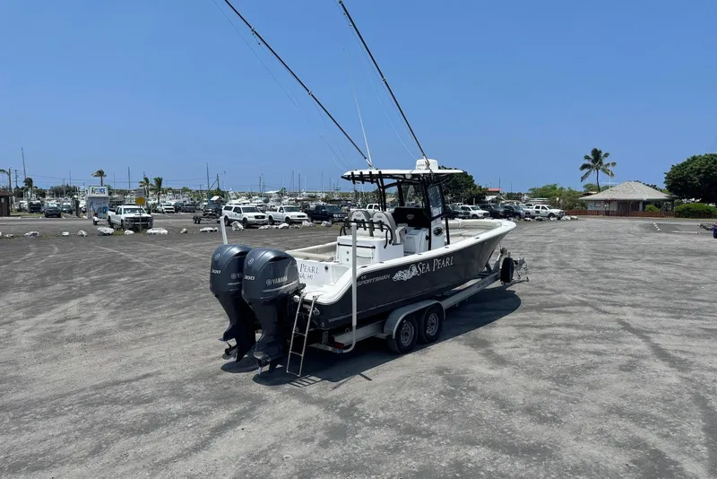 Slide: The Image of 2021 Sportsman Open 282 Center Console boat on trailer in sunny marina parking lot. - 5