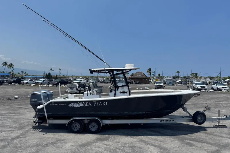 Slide: The Image of 2021 Sportsman Open 282 Center Console boat on trailer in sunny marina. - 6
