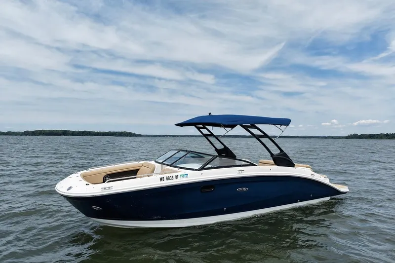 Slide: The Image of 2021 Sea Ray SDX 270 boat on calm water under a partly cloudy sky. - 1