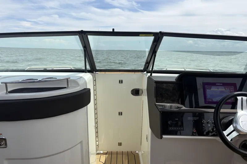 Slide: The Image of 2021 Sea Ray SDX 270 boat interior with tan and black seating, featuring hexagonal patterns. - 10