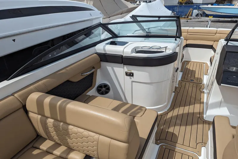 Slide: The Image of Interior of 2021 Sea Ray SDX 270 boat with tan seating and wood flooring. - 14