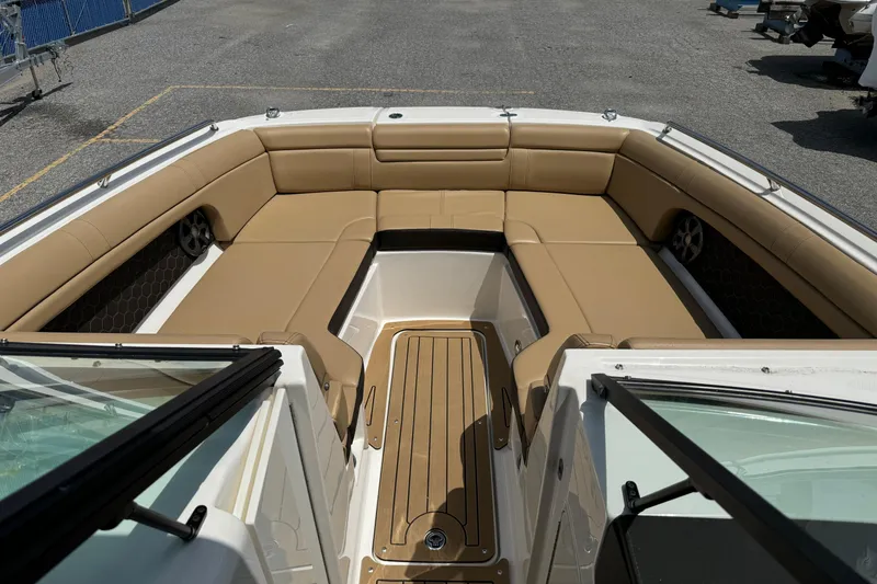 Slide: The Image of 2021 Sea Ray SDX 270 boat interior with tan seating and spacious layout. - 16