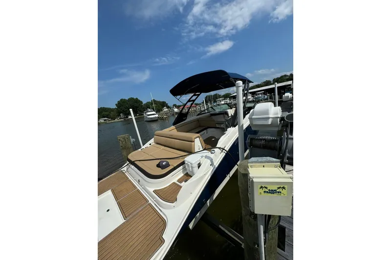 Slide: The Image of 2021 Sea Ray SDX 270 boat docked, featuring spacious seating and sleek design. - 18
