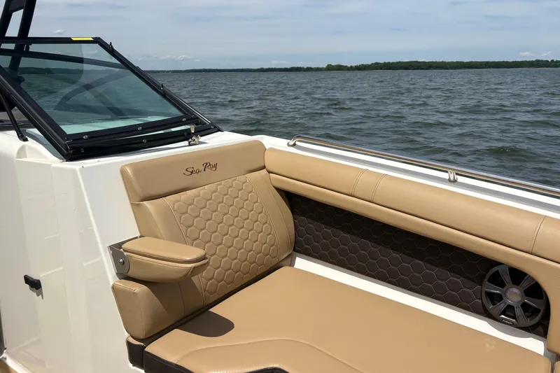 Slide: The Image of 2021 Sea Ray SDX 270 boat on trailer, parked on driveway with lush trees. - 21
