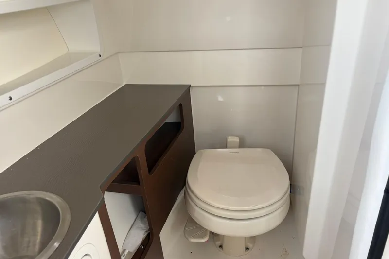 Slide: The Image of 2021 Sea Ray SDX 270 boat interior with tan leather seating and hexagonal stitching. - 9