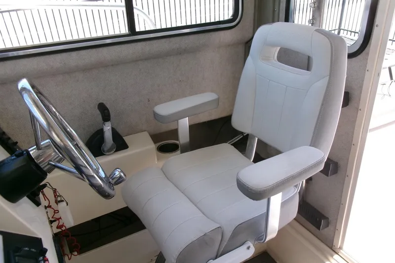 Slide: The Image of Captain's chair and steering wheel in 2011 Parker 2320 SL Sport Cabin boat. - 10