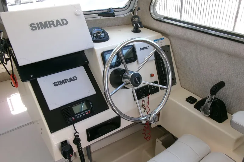 Slide: The Image of Interior of 2011 Parker 2320 SL Sport Cabin with Simrad navigation equipment. - 11