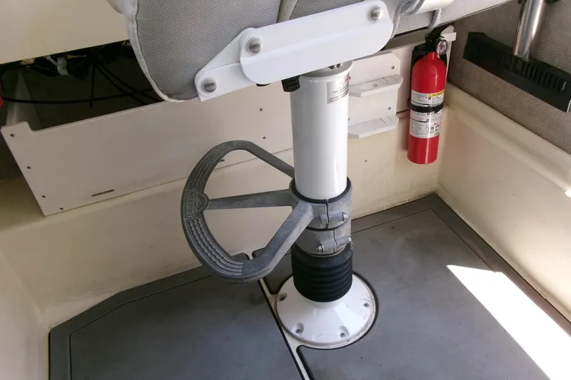 Slide: The Image of Boat interior with adjustable seat pedestal and fire extinguisher, Parker 2320 SL Sport Cabin, 2011. - 12