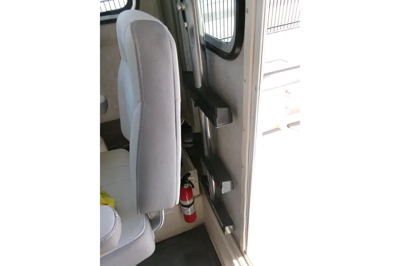 Slide: The Image of Interior of 2011 Parker 2320 SL Sport Cabin with seat and fire extinguisher. - 13