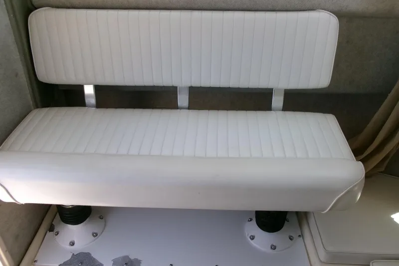 Slide: The Image of White cushioned bench seat inside 2011 Parker 2320 SL Sport Cabin boat. - 15