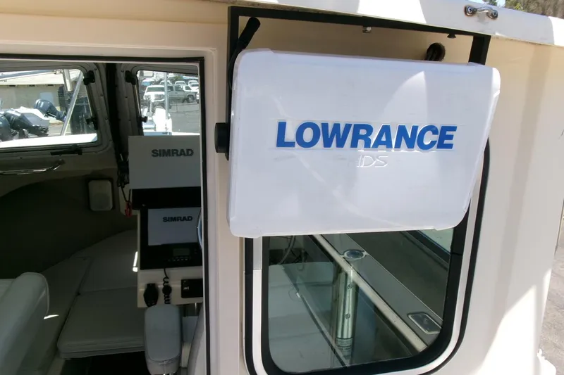 Slide: The Image of 2011 Parker 2320 SL Sport Cabin with Lowrance and Simrad navigation systems. - 16