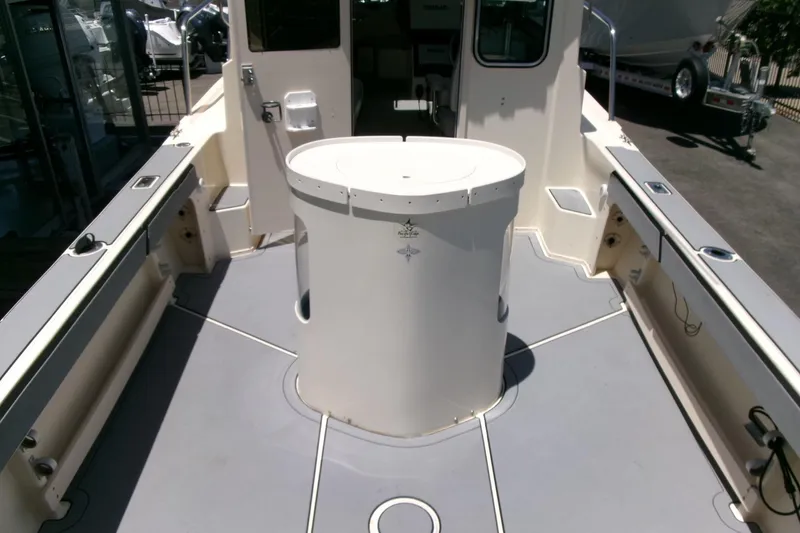 Slide: The Image of 2011 Parker 2320 SL Sport Cabin boat interior with central storage compartment. - 20