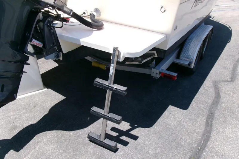 Slide: The Image of Rear view of 2011 Parker 2320 SL Sport Cabin boat with ladder and trailer. - 25