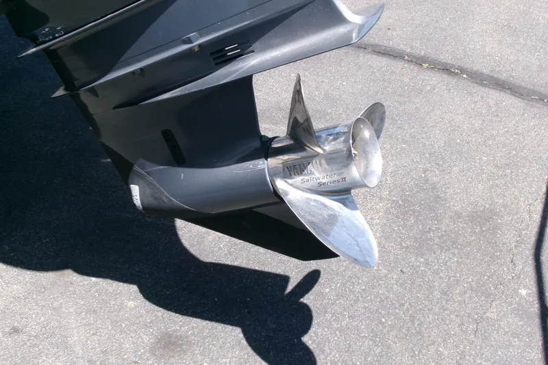 Slide: The Image of Propeller of a 2011 Parker 2320 SL Sport Cabin boat on pavement. - 26
