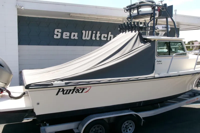 Slide: The Image of 2011 Parker 2320 SL Sport Cabin boat on trailer, covered, outside Sea Witch Marine. - 27