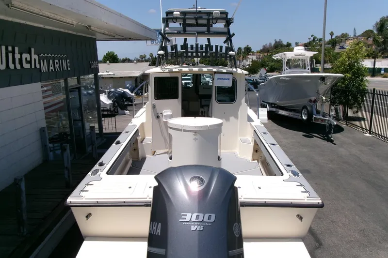 Slide: The Image of 2011 Parker 2320 SL Sport Cabin boat with Yamaha 300 V6 engine at a marine dealership. - 28