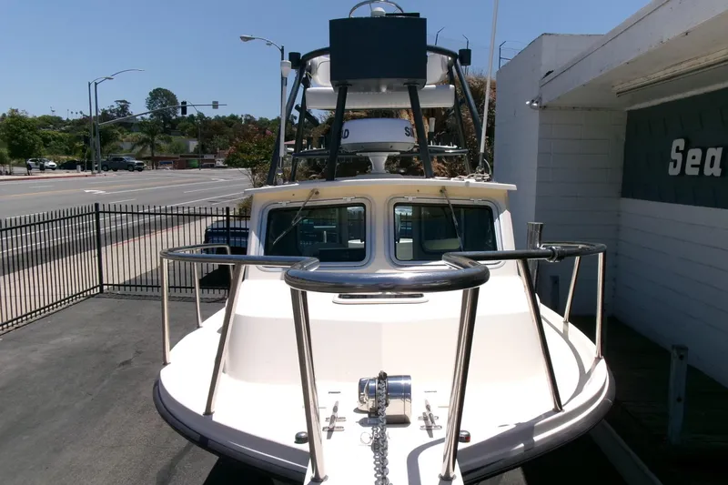 Slide: The Image of 2011 Parker 2320 SL Sport Cabin boat parked near a street, front view. - 29