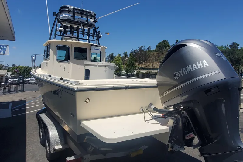Slide: The Image of 2011 Parker 2320 SL Sport Cabin boat with Yamaha outboard motor on trailer. - 3