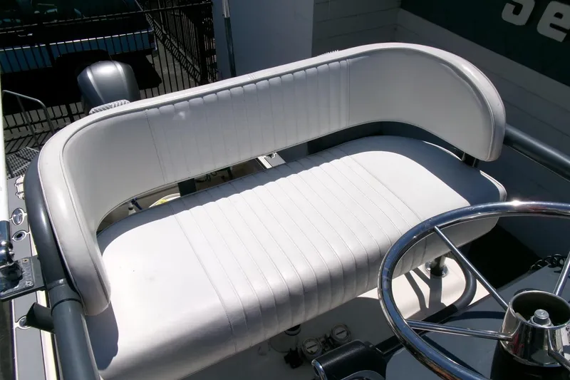 Slide: The Image of White cushioned seat and steering wheel on 2011 Parker 2320 SL Sport Cabin boat. - 7
