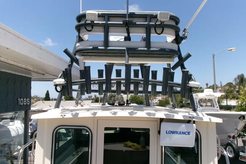 Slide: The Image of 2011 Parker 2320 SL Sport Cabin boat with fishing rod holders and Lowrance equipment. - 8