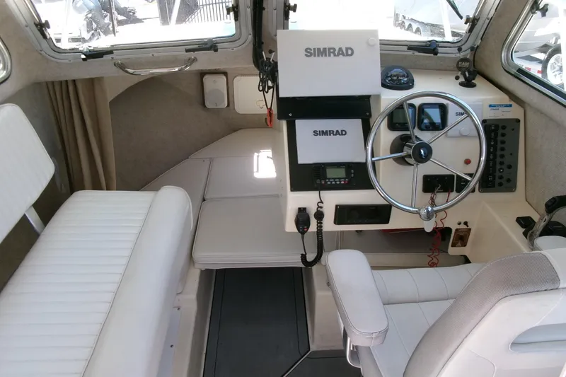 Slide: The Image of Interior of 2011 Parker 2320 SL Sport Cabin with steering wheel and Simrad electronics. - 9