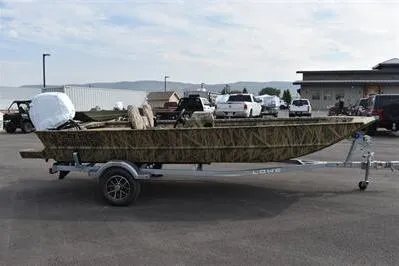 The Image of 2025 Lowe Roughneck 1860SC boat on trailer in parking lot, side view. - 0
