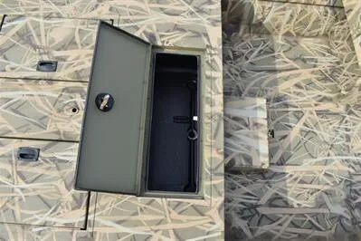 Slide: The Image of 2025 Lowe Roughneck 1860SC boat with open storage compartment, camo pattern design. - 11