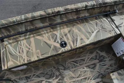 Slide: The Image of 2025 Lowe Roughneck 1860SC boat with camouflage design and storage compartment. - 13