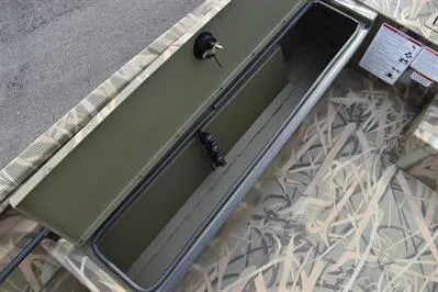Slide: The Image of 2025 Lowe Roughneck 1860SC boat storage compartment with camouflage pattern and secure latch. - 14
