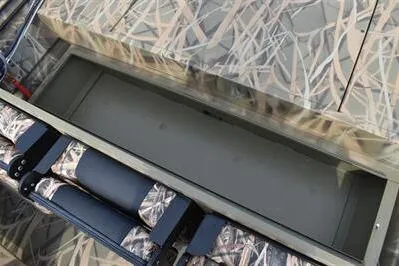 Slide: The Image of 2025 Lowe Roughneck 1860SC boat interior with camouflage seating and storage compartment. - 16