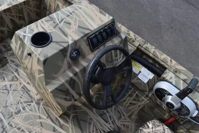 Slide: The Image of 2025 Lowe Roughneck 1860SC boat console with camouflage design and steering wheel. - 17