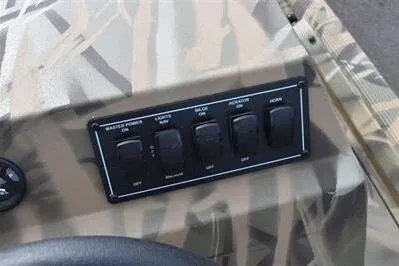 Slide: The Image of Control panel of 2025 Lowe Roughneck 1860SC boat with switches for various functions. - 18
