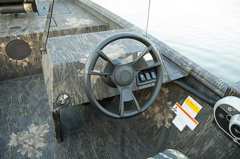 Slide: The Image of Manufacturer Provided Image: 2025 Lowe Roughneck 1860SC boat interior with camo design and steering wheel. - 25