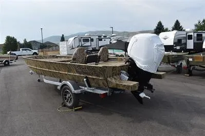 Slide: The Image of 2025 Lowe Roughneck 1860SC boat on trailer, camo design, parked outdoors. - 5