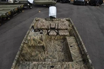 Slide: The Image of 2025 Lowe Roughneck 1860SC boat with camouflage interior, parked on asphalt. - 8