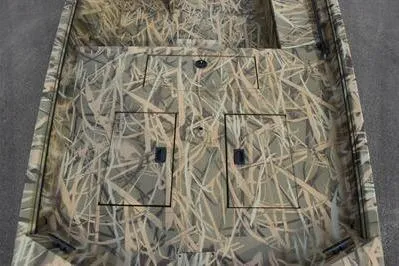 Slide: The Image of 2025 Lowe Roughneck 1860SC boat with camouflage design and storage compartments. - 9