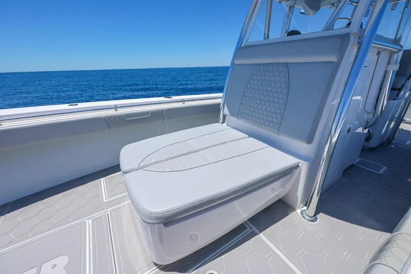 Slide: The Image of 2023 Contender 35 ST boat interior with cushioned seating, ocean view, and sleek design. - 14