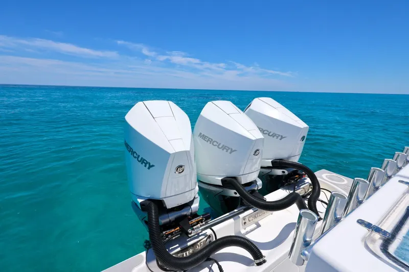 Slide: The Image of 2023 Contender 35 ST boat with triple Mercury outboard engines on clear blue ocean. - 17