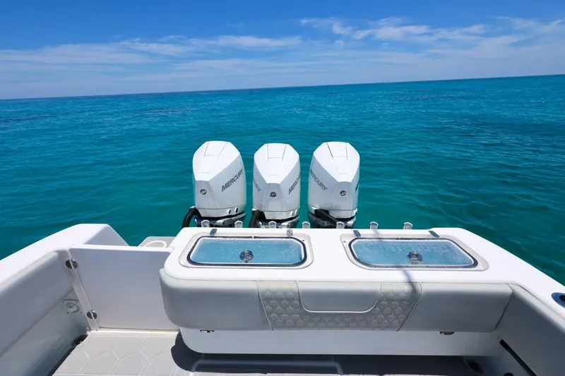 Slide: The Image of 2023 Contender 35 ST boat with triple Mercury engines on clear blue ocean. - 18