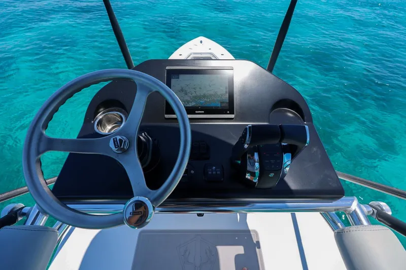 Slide: The Image of Steering console of 2023 Contender 35 ST boat with clear blue ocean backdrop. - 19