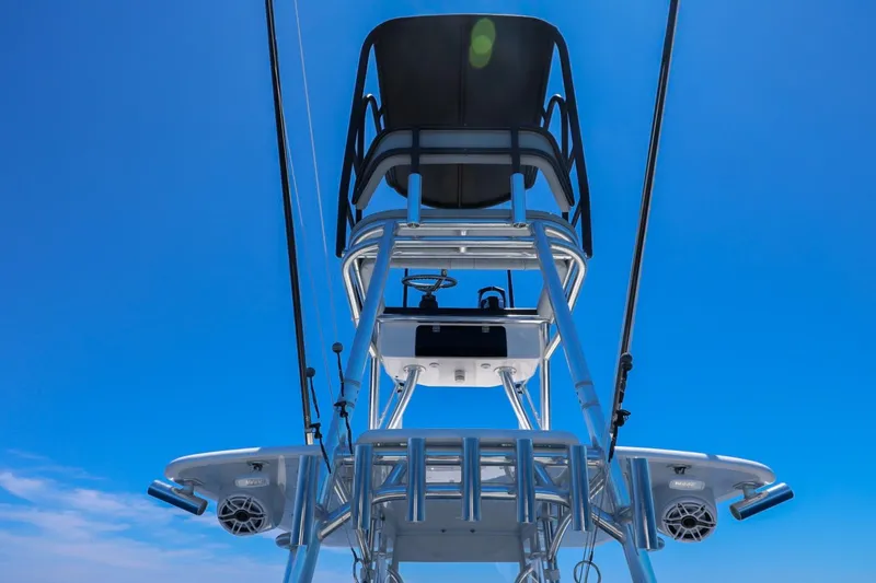 Slide: The Image of 2023 Contender 35 ST boat tower against clear blue sky, showcasing sleek design and structure. - 20