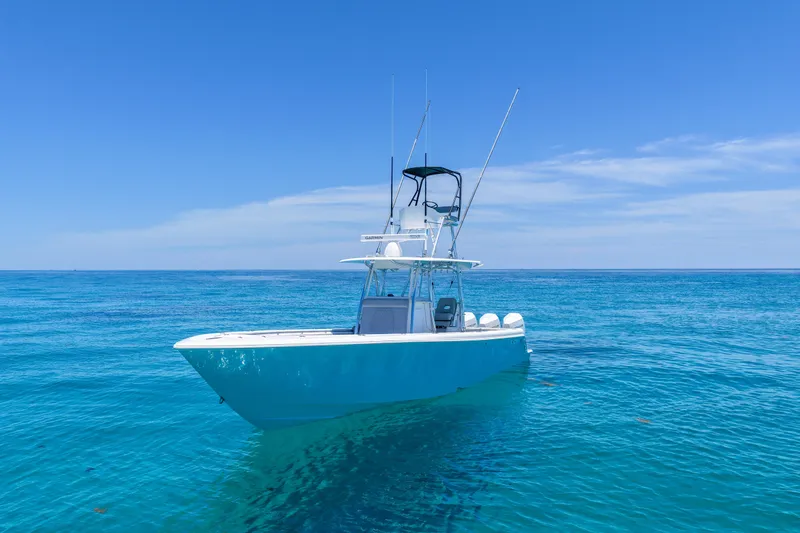 Slide: The Image of 2023 Contender 35 ST boat on clear blue ocean under sunny sky. - 4
