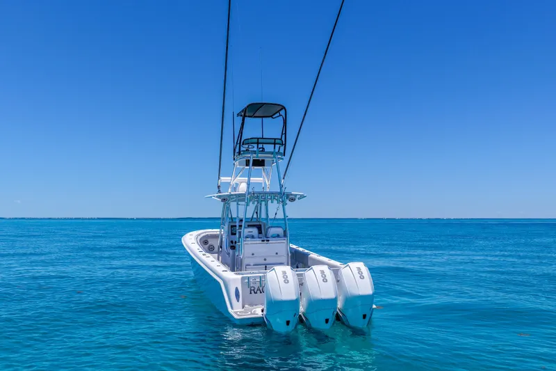 Slide: The Image of 2023 Contender 35 ST boat with triple engines on clear blue ocean. - 8