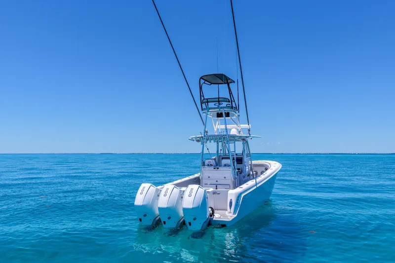 Slide: The Image of 2023 Contender 35 ST boat with triple engines on clear blue ocean. - 9