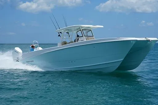 The Image of 2026 Twin Vee 340 GFX CC boat cruising on clear blue ocean water. - 1