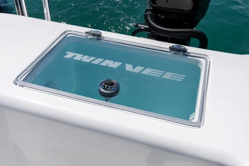 Slide: The Image of 2026 Twin Vee 340 GFX CC boat detail with logo on glass panel. - 13