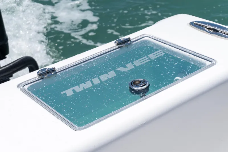 Slide: The Image of 2026 Twin Vee 340 GFX CC boat detail with water droplets on glass panel. - 15
