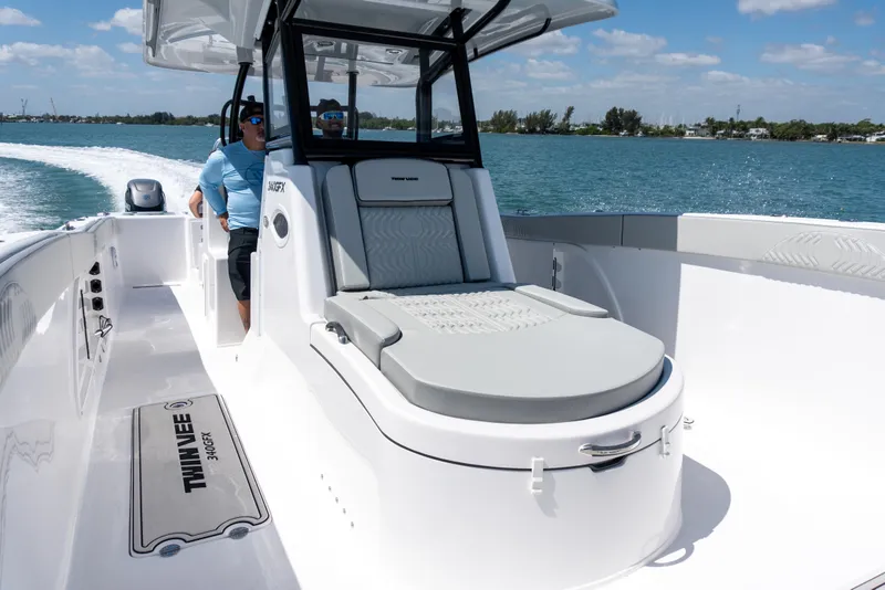 Slide: The Image of 2026 Twin Vee 340 GFX CC boat cruising on a sunny day, featuring sleek design and comfortable seating. - 3